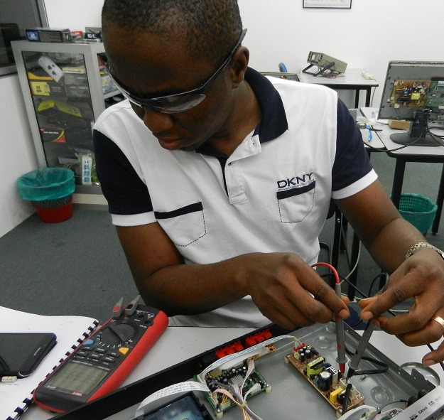 nigerian student in electronic repair course