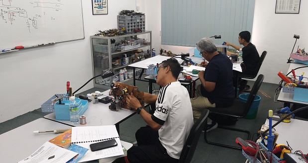 Singapore and trinidad and tobago students in electronics training repair course